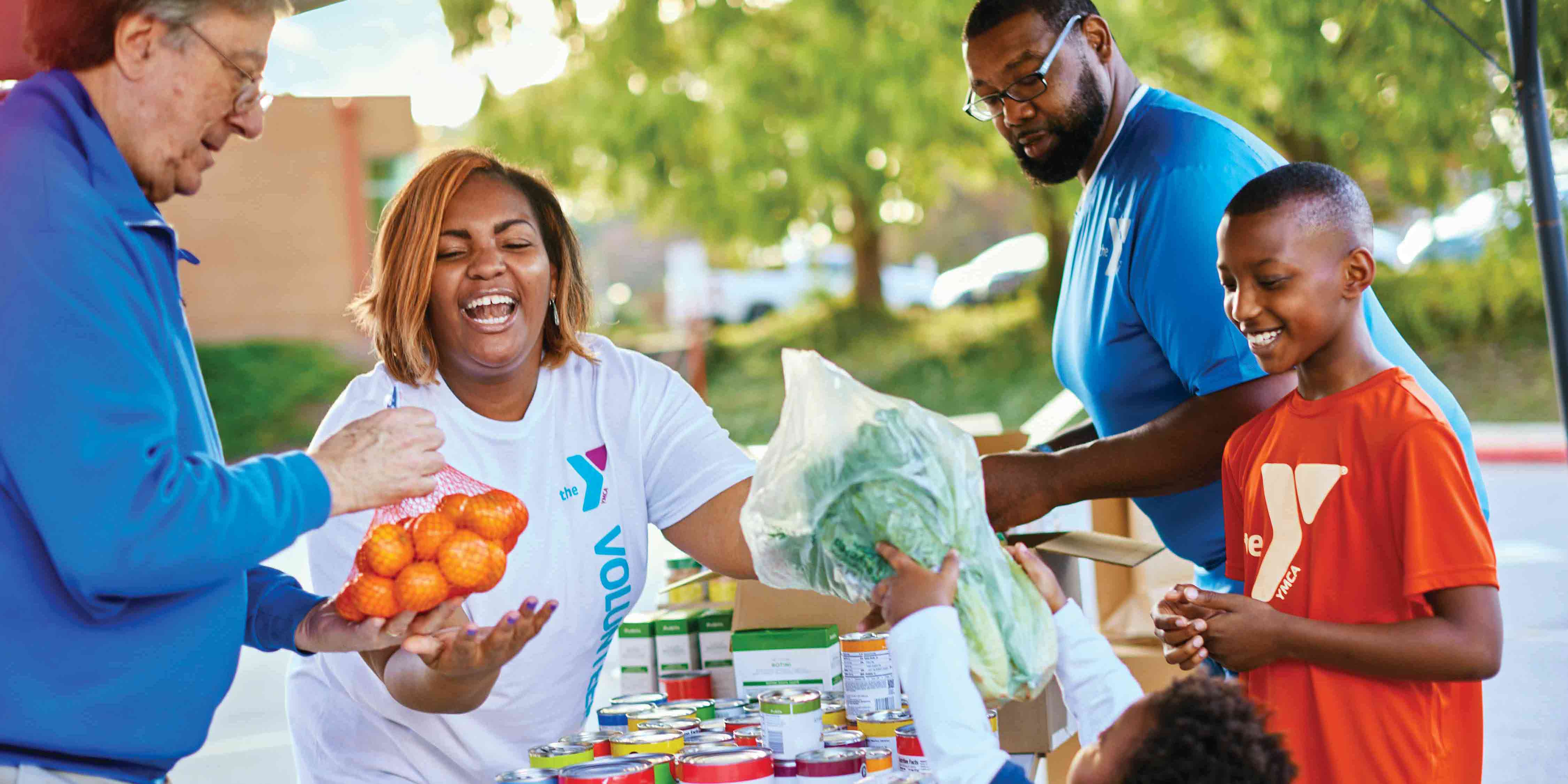 Exterior photo of family handing out produce